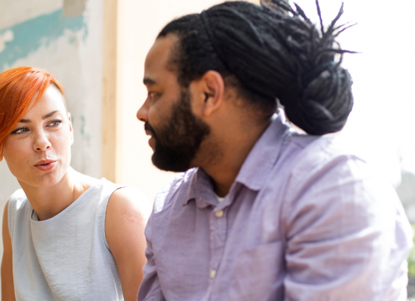 Two people facing each other and talking.